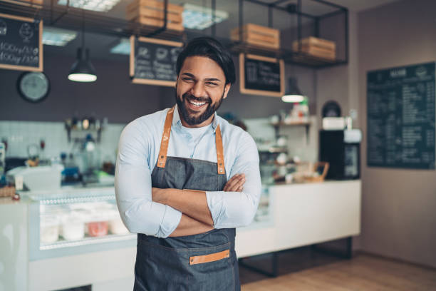 Portrait of a smiling young man in a cafeteria